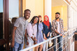 © Evgeniia - Multiracial young friends posing at the balcony of cafe. They laughing and having fun together.
