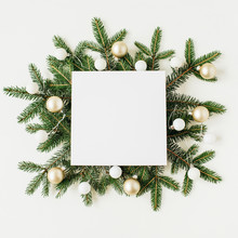 Christmas / New Year Composition. Gift Box With Blank Frame Copy Space, Fir Branches, Christmas Baubles On White Background. Flat Lay, Top View Festive Holiday Mockup.