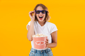 Poster - Image of woman in 3D glasses holding popcorn bucket while watching movie