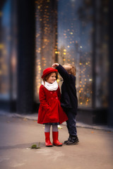 funny couple of children hug, Christmas lights