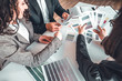 © HBS - Top view cropped image of young couple looking at catalog color examples for building decoration. Professional designer helps to choose color on swatches to sucessful family. Design studio concept