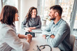 © HBS - Side view image of happy young family at doctor appointment, enjoying good results of progressive therapy after medical tests. Health and medicine concept