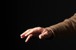 © Andrea - open male hand isolated on black background with copy space for your text