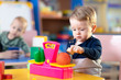© Oksana Kuzmina - Cute little kid boy playing with abacus in nursery. Preschooler having fun with educational toy in daycare or creche. Smart child learning to count.