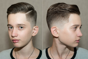 Stylish modern retro haircut side part with mid fade with parting of a school boy guy in a barbershop on a brown background