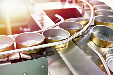 Empty cans on conveyor of food factory