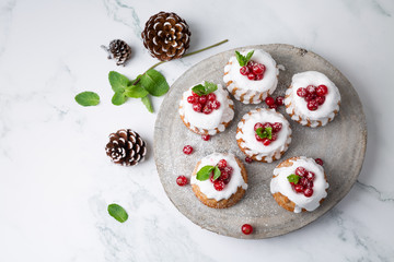 Wall Mural - Small Christmas cakes with berries on a wood slice