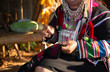 The Akha woman is sewing