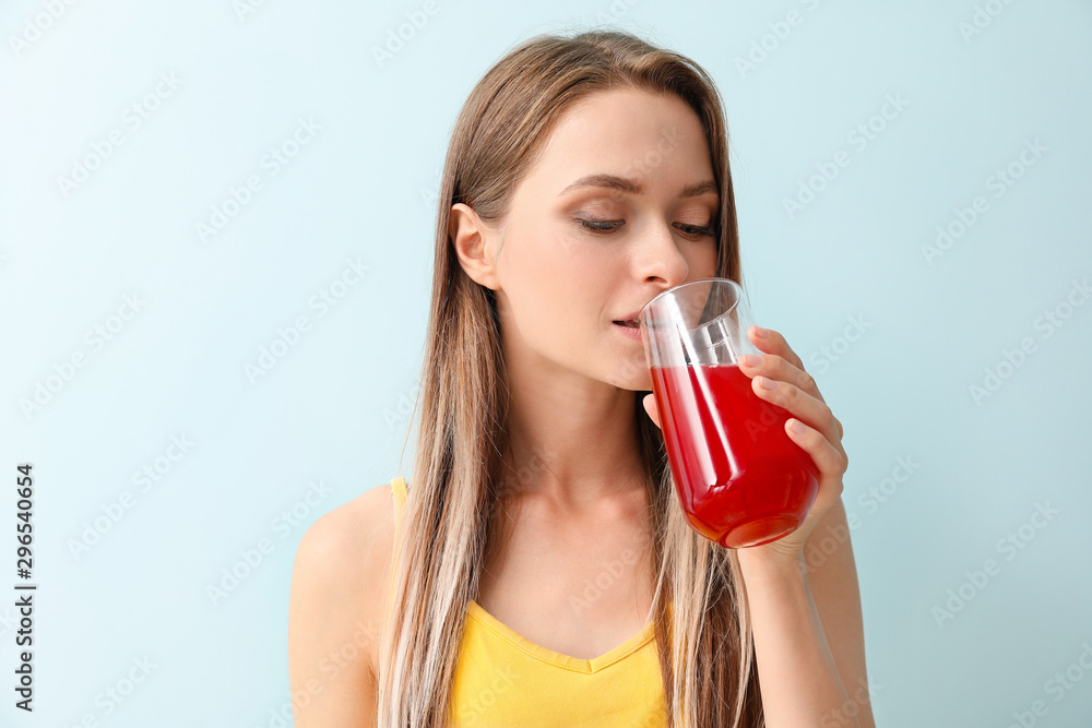 Woman drinking healthy juice on light background. Diet concept