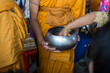 © Suwatchai - Buddhist monks are given food offering from people for End of Buddhist Lent Day