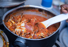 A Close Up Shot Of A Piece Of Crab Dished From A Pot Of Stew