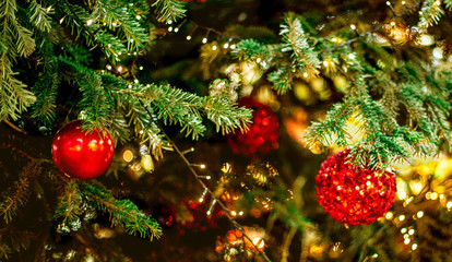 Wall Mural - christmas tree and christmas decorations with hanging red baubles and golden sparkling lights. happy