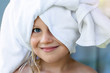 © Kirill Gorlov - Cute adorable caucasian little blond girl wearing white towel on we head after shower or bathing at bathroom. Portrait of cheerful smiling female child