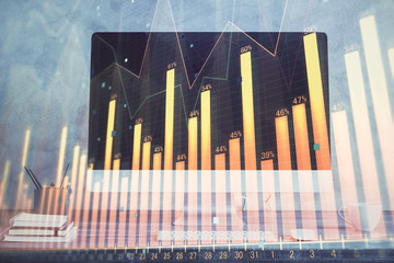 Stock market graph and table with computer background. Double exposure. Concept of financial analysis.