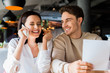 © LIGHTFIELD STUDIOS - selective focus of happy man near cheerful woman talking on smartphone