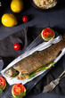 baked trout with herb filling and tomatoes