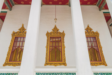 The beautiful of thai style windows. External view of the church in Wat Ratchanaddaram