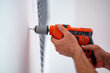 Drilling a hole on the wall for construction or renovation