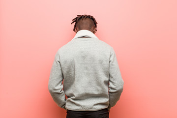 Wall Mural - Young fitness african black man from behind, looking back.