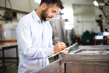 The engineer oversees the process of working in an electrical workshop,stock photo