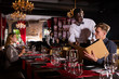 © JackF - African American waiter helping client with menu