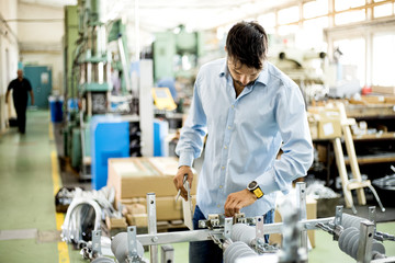 The engineer oversees the process of working in an electrical workshop,stock photo