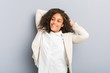 © Asier - Young african american business woman stretching arms, relaxed position.