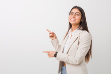 Young Business Arab Woman Isolated Against A White Background Excited Pointing With Forefingers Away.