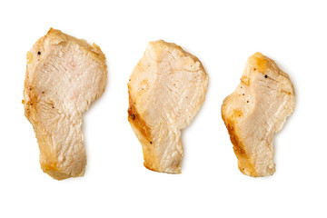 Wall Mural - Three separated slices of grilled chicken breast isolated on white. Top view.