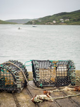 Crab Traps On The Pier Bay And Boats In The Background