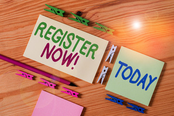 Handwriting text Register Now. Conceptual photo official list or record showing or things into web or forum Colored clothespin papers empty reminder wooden floor background office