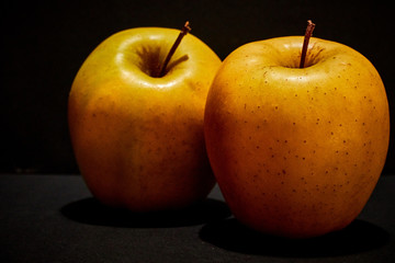 Apples on very black background