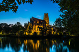 Fototapeta Nowy Jork - Germany, Famous stuttgart feuersee church building illuminated by night in downtown reflecting in water in magical light by night