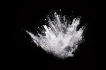 White powder explosion on black background. Colored cloud. Colorful dust explode. Paint Holi.