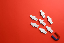 Magnet Attracting Paper People On Red Background, Flat Lay. Space For Text