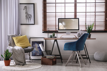 Poster - comfortable workplace near window with horizontal blinds in room