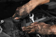 © New Africa - Dirty mechanic fixing car, closeup of hands