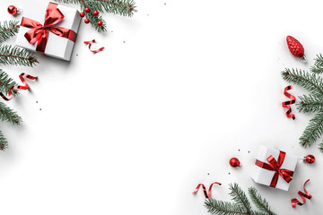 Wall Mural - christmas fir branches, gift boxes with red ribbon, red decoration, sparkles and confetti on white b