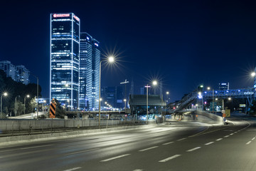 Wall Mural - Empty Freeway At Night And Tel Aviv Skyline in Background