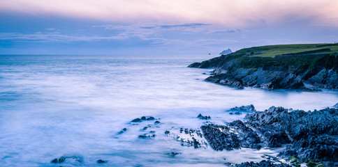 Wall Mural - a viewpoint from bray head on valentia island in the ring of kerry in the south west coast of ireland during an autumn sunset showing the skellig islands and watchtower