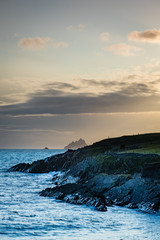 Wall Mural - a viewpoint from bray head on valentia island in the ring of kerry in the south west coast of ireland during an autumn sunset showing the skellig islands and watchtower