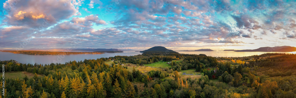 Sunset Aerial View of Rural Lummi Island, Washington. Located in the Puget Sound area of Washington state this rural island offers a peaceful retreat and boasts the famous award winning Willows Inn. - obrazy, fototapety, plakaty 