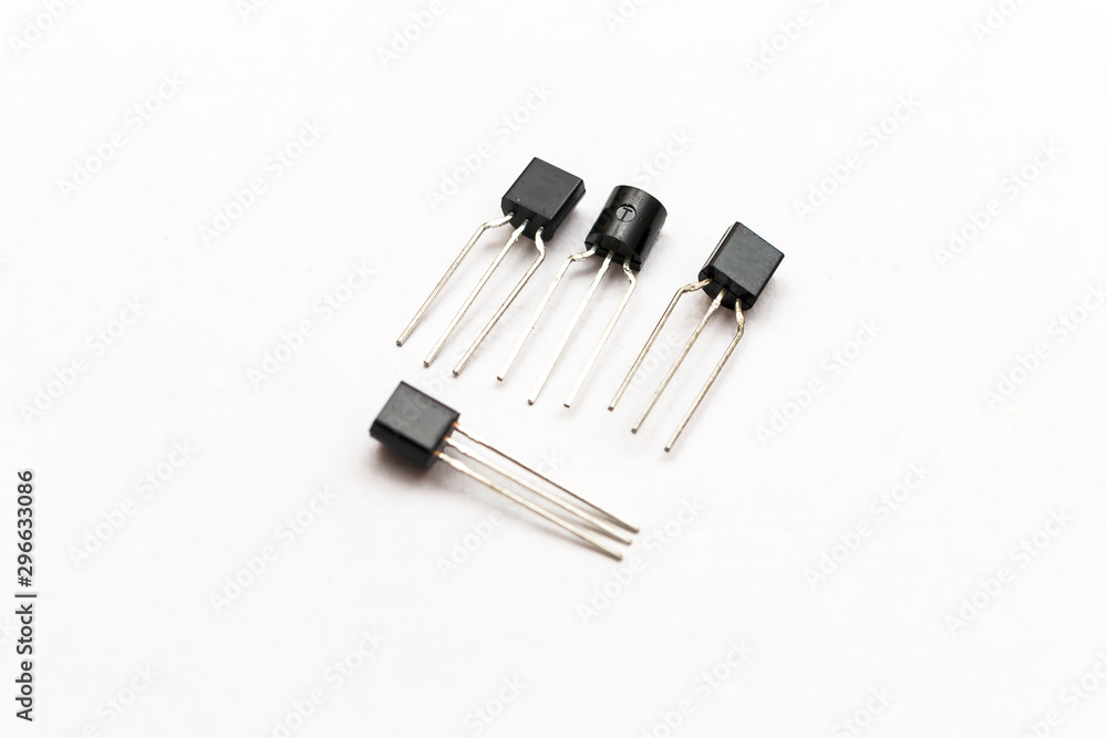 Stack of low power transistors in package TO-92 on a white background ...
