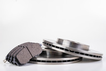 Steel Brake Discs And Brake Pads For A Passenger Car. New Spare Parts For Car Repairs.