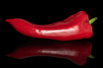 One whole sweet red bell pepper isolated on black glass