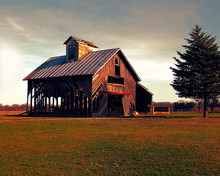 Photo Of An Old Abandoned Barn In The Country With A Dark Sky.