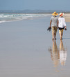 Elder couple walking on beach 