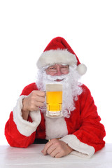 Wall Mural - Closeup of Santa Claus holding a mug of beer, isolated on white.