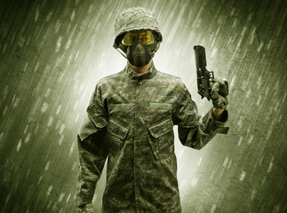 Armed soldier standing in rainy weather