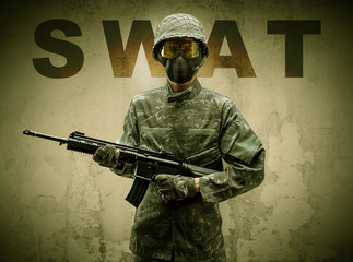 Uniformed armed soldier with damaged wall background